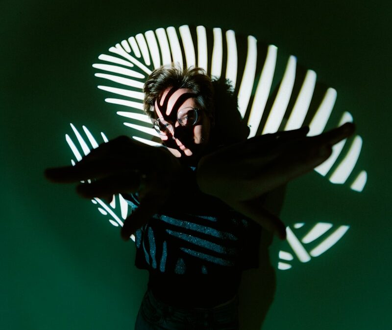 Person with striped light projection on face and around them.